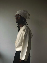 a man wearing a white shirt and black pants